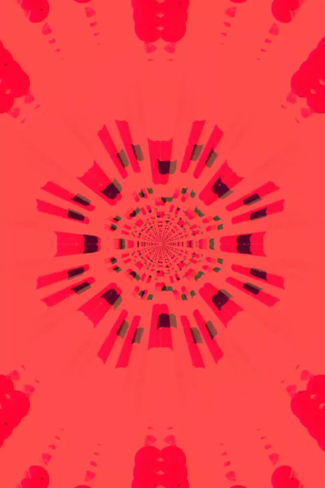 Czerwony neon kalejdoskop wybuch promieniujący ze środka, symetryczny efekt tunelu z karmazynowymi i ciemnoczerwonymi kształtami geometrycznymi spiralującymi do wewnątrz w abstrakcyjnej pętli VJ