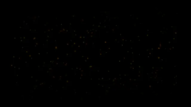 Golden Particles Floating on Black Background